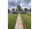 Expansive front yard leading to a modest home, showcasing a classic suburban setting at 2655 Pontiac St, Denver, CO 80207