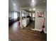 Open-concept living space featuring hardwood floors and abundant natural light, seamlessly connecting to the kitchen at 2655 Pontiac St, Denver, CO 80207