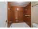 Bathroom with retro brown tile shower and tub, complemented by modern fixtures at 4801 E 9Th Ave # 108S, Denver, CO 80220