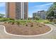 Condo building exterior with landscaped green space, walking path, seating and an outdoor arbor at 4801 E 9Th Ave # 108S, Denver, CO 80220