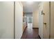 Hallway view of kitchen and living area, featuring hardwood floors and abundant natural light at 4801 E 9Th Ave # 108S, Denver, CO 80220