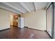 Open living area with a galley kitchen, hardwood floors, a sliding glass door, and a neutral color scheme at 4801 E 9Th Ave # 108S, Denver, CO 80220