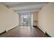Bright living area with hardwood floors, sliding glass doors, and a neutral color scheme, showcasing modern living at 4801 E 9Th Ave # 108S, Denver, CO 80220