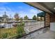 Outdoor patio with a metal railing, offering views of the building, parking and neighborhood at 4801 E 9Th Ave # 108S, Denver, CO 80220