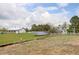 Backyard featuring a solar panel, barn, and white fence, perfect for sustainable living at 31 N Algonquian St, Aurora, CO 80018