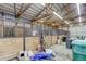 Barn interior featuring wooden stalls, metal bars, lighting, and storage space at 31 N Algonquian St, Aurora, CO 80018