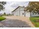 Spacious white barn with concrete driveway and large sliding doors, perfect for storage or livestock at 31 N Algonquian St, Aurora, CO 80018