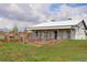 Modern barn with attached horse pen and three horses in the pen on a beautiful day at 31 N Algonquian St, Aurora, CO 80018