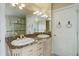 Bathroom with double vanity, granite countertop, stylish hardware, and a glass-enclosed shower at 31 N Algonquian St, Aurora, CO 80018