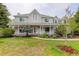 Inviting two-story home with a charming front porch, mature trees, and a well-manicured lawn at 31 N Algonquian St, Aurora, CO 80018