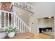Bright foyer with staircase, white railings, hardwood floors, and a view into an office space at 31 N Algonquian St, Aurora, CO 80018