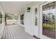 Spacious front porch with decorative railing and a stylish front door with glass inserts at 31 N Algonquian St, Aurora, CO 80018