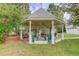 Backyard gazebo with seating, fan, and manicured landscaping at 31 N Algonquian St, Aurora, CO 80018
