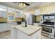 Well-lit kitchen with an island, stainless steel appliances, and ample counter space at 31 N Algonquian St, Aurora, CO 80018