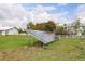 Backyard solar panel installation with a modern barn and white fence on a grassy lawn at 31 N Algonquian St, Aurora, CO 80018