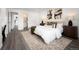 Bright, spacious bedroom featuring modern decor, a large bed, and an ensuite bathroom at 2123 N Coronado Pkwy # C, Denver, CO 80229