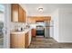 Well-lit kitchen with wood cabinets and stainless steel appliances at 2123 N Coronado Pkwy # C, Denver, CO 80229