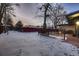 Snowy backyard with wood deck and red fence at 6127 S Westview St, Littleton, CO 80120