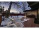 Snow-covered deck with lighting, wood fencing, and a view of the backyard at 6127 S Westview St, Littleton, CO 80120