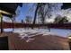 Snow-covered deck with lighting, wood fencing, and a view of the backyard at 6127 S Westview St, Littleton, CO 80120