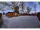 View of backyard, home, and snowy ground at 6127 S Westview St, Littleton, CO 80120