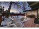 Backyard deck with snow on the ground and landscape lighting at 6127 S Westview St, Littleton, CO 80120