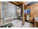 Bathroom with wood-paneled walls, tile flooring, and a glass-enclosed shower at 6127 S Westview St, Littleton, CO 80120