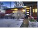 Mid-century modern home with wood siding and snowy yard at 6127 S Westview St, Littleton, CO 80120