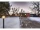 Mid-century modern home with a driveway and snowy front yard at 6127 S Westview St, Littleton, CO 80120