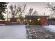 Mid-century modern home with a carport and snowy front yard at 6127 S Westview St, Littleton, CO 80120