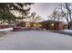 Single story home with a long driveway and front yard covered in snow at 6127 S Westview St, Littleton, CO 80120