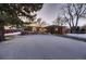 Ranch style home with snow covered lawn at 6127 S Westview St, Littleton, CO 80120