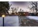 Landscaped front yard with driveway and snowy lawn at 6127 S Westview St, Littleton, CO 80120