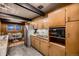 Retro kitchen with wood cabinets and stainless steel appliances at 6127 S Westview St, Littleton, CO 80120