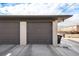 Two-car garage with dark gray doors and light brick exterior at 5217 E Martin Luther King Jr Blvd, Denver, CO 80207