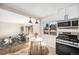 Modern kitchen with white cabinets, stainless steel appliances, and breakfast nook at 5217 E Martin Luther King Jr Blvd, Denver, CO 80207