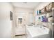 Bright laundry room features washer, dryer, and ample storage shelving at 5217 E Martin Luther King Jr Blvd, Denver, CO 80207