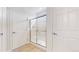 Bathroom with glass-enclosed shower, neutral tile, and white cabinets at 16224 Cirque Mountain Way, Broomfield, CO 80023