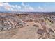 Large aerial view displays the suburban neighborhood surrounded by green fields and hills in the distance at 20830 Scenic Park Dr, Parker, CO 80138