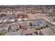 An aerial view of a suburban neighborhood showcasing homes with well-maintained lawns and tree-lined streets in a close-knit community at 20830 Scenic Park Dr, Parker, CO 80138