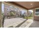 Inviting covered back patio area with wood deck overlooks fenced yard and neighboring buildings at 20830 Scenic Park Dr, Parker, CO 80138