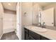 Modern bathroom boasts gray tile flooring, sleek black cabinets, quartz countertops, and shower/tub combo at 20830 Scenic Park Dr, Parker, CO 80138