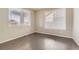 Bright bedroom with hardwood flooring, neutral walls, and two large windows for ample natural light at 20830 Scenic Park Dr, Parker, CO 80138