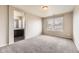 Spacious bedroom featuring a modern bathroom entrance, plush carpet and natural light from a large window at 20830 Scenic Park Dr, Parker, CO 80138