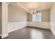 Elegant dining room featuring wainscoting, a tray ceiling, and a modern chandelier at 20830 Scenic Park Dr, Parker, CO 80138
