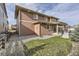 Rear exterior view showcases the house's siding, covered patio, and gravel landscaping at 20830 Scenic Park Dr, Parker, CO 80138