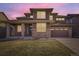 Inviting two-story home with brick and siding, a welcoming front porch, and a two-car garage at 20830 Scenic Park Dr, Parker, CO 80138