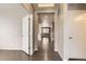 Spacious hallway with hardwood floors and neutral paint, leading to other rooms at 20830 Scenic Park Dr, Parker, CO 80138