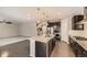 Open-concept kitchen with stainless steel appliances, a center island, and seamless connection to living area at 20830 Scenic Park Dr, Parker, CO 80138