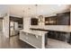 Stylish kitchen with dark cabinetry, granite countertops, stainless steel appliances, and a large island at 20830 Scenic Park Dr, Parker, CO 80138